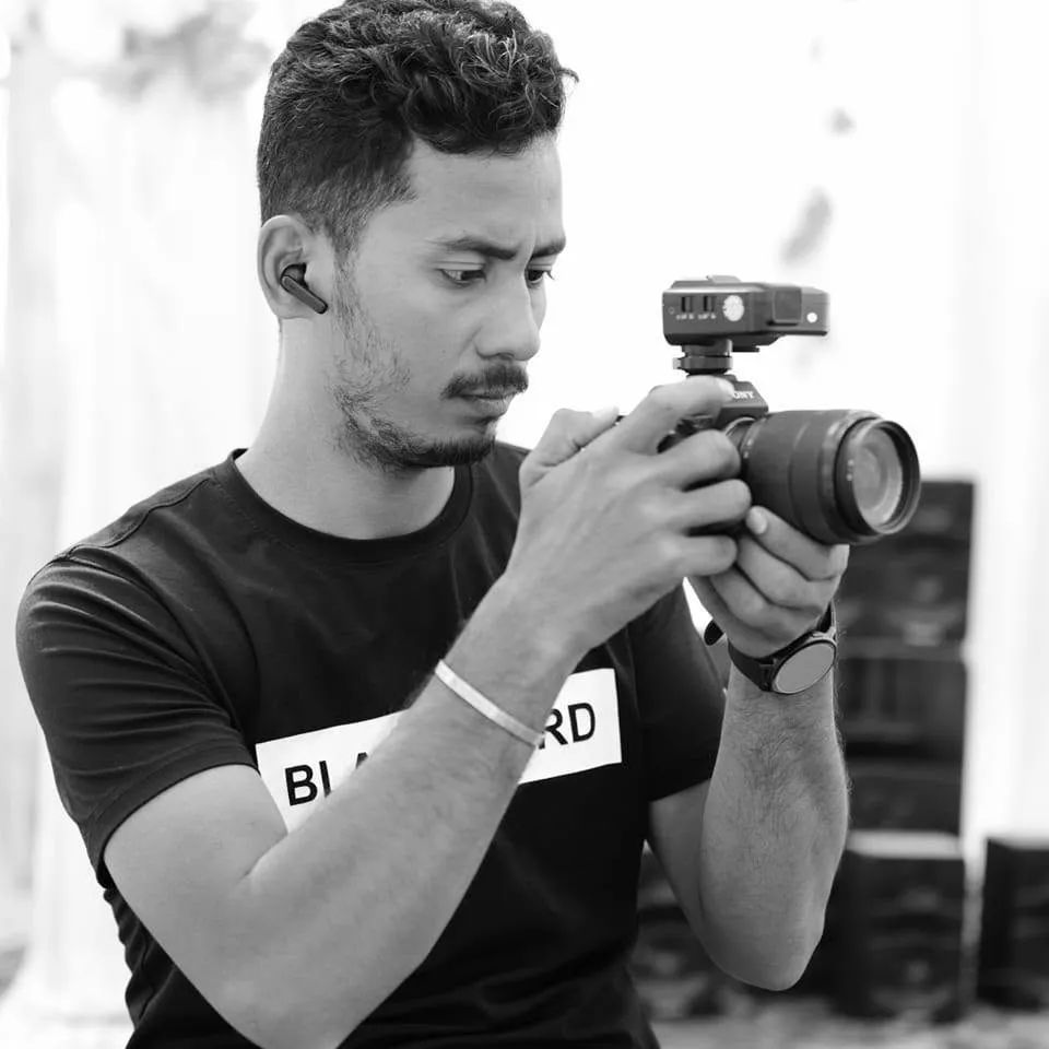 Team member posing with camera