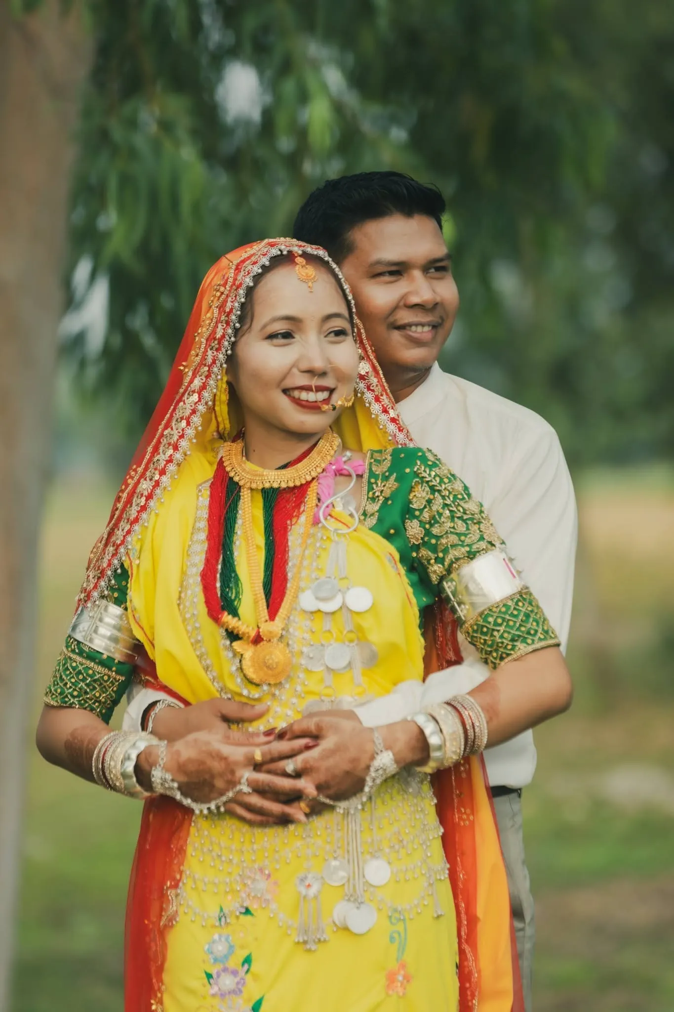 Groom holding bridge from behind
